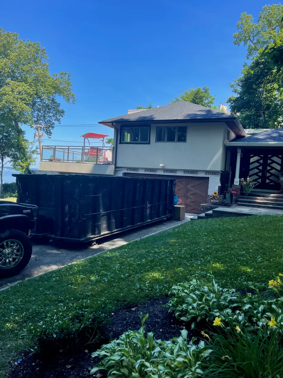 Pyrate Dumpsters roll-off dumpster delivered to a single-family home driveway in Plainview, NY